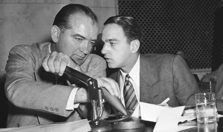 Senator Joe McCarthy confers with aide Roy Cohn